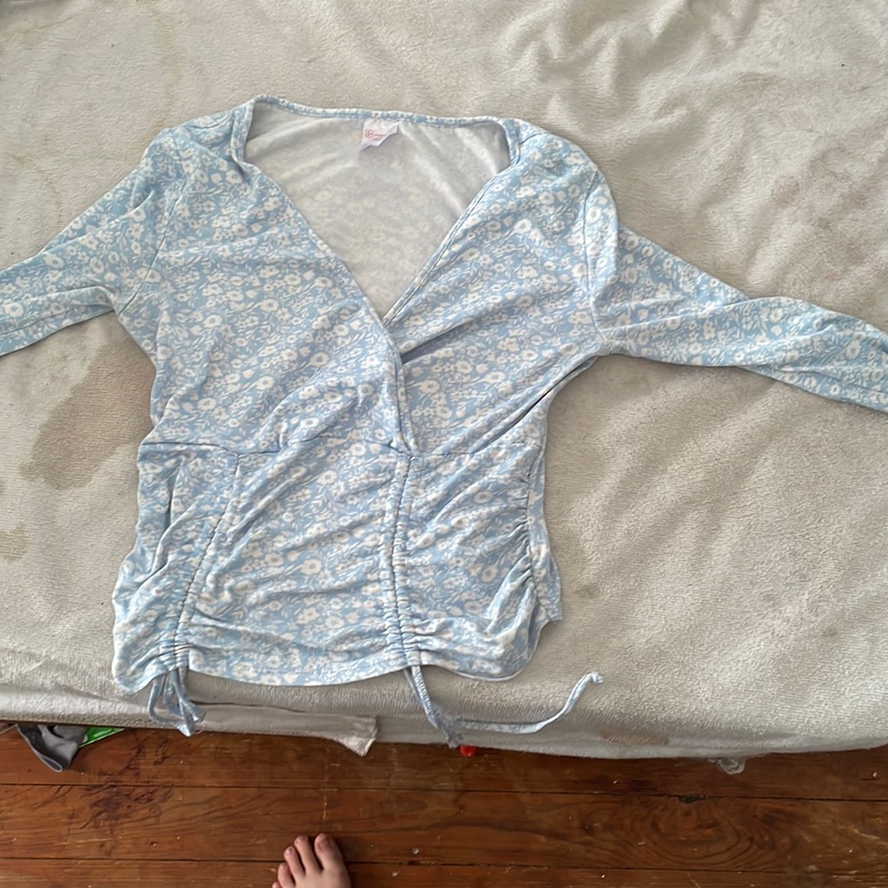 I’m selling a flower blue tight long sleeved shirt tight at the waist and opened